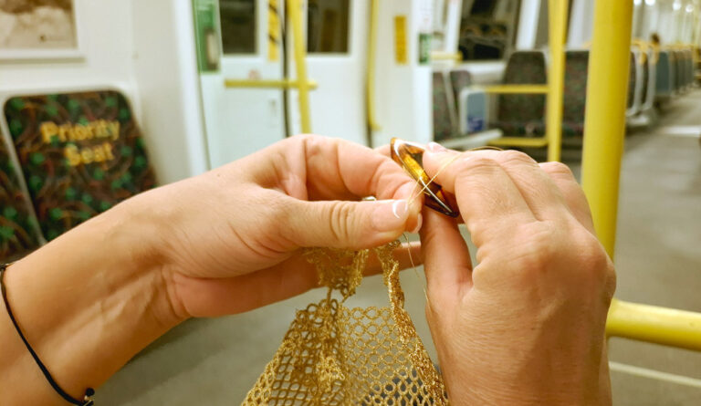 Hands tatting lace on a train, showing how to find time for a hobby in a busy life