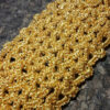 Gold Tatting Bracelet – Close-up Detail Close-up of a gold knitted tatting bracelet fragment without beads, highlighting intricate lace patterns.