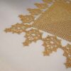free tatting doily pattern corner close-up showing leaf edging gold on cream satin
