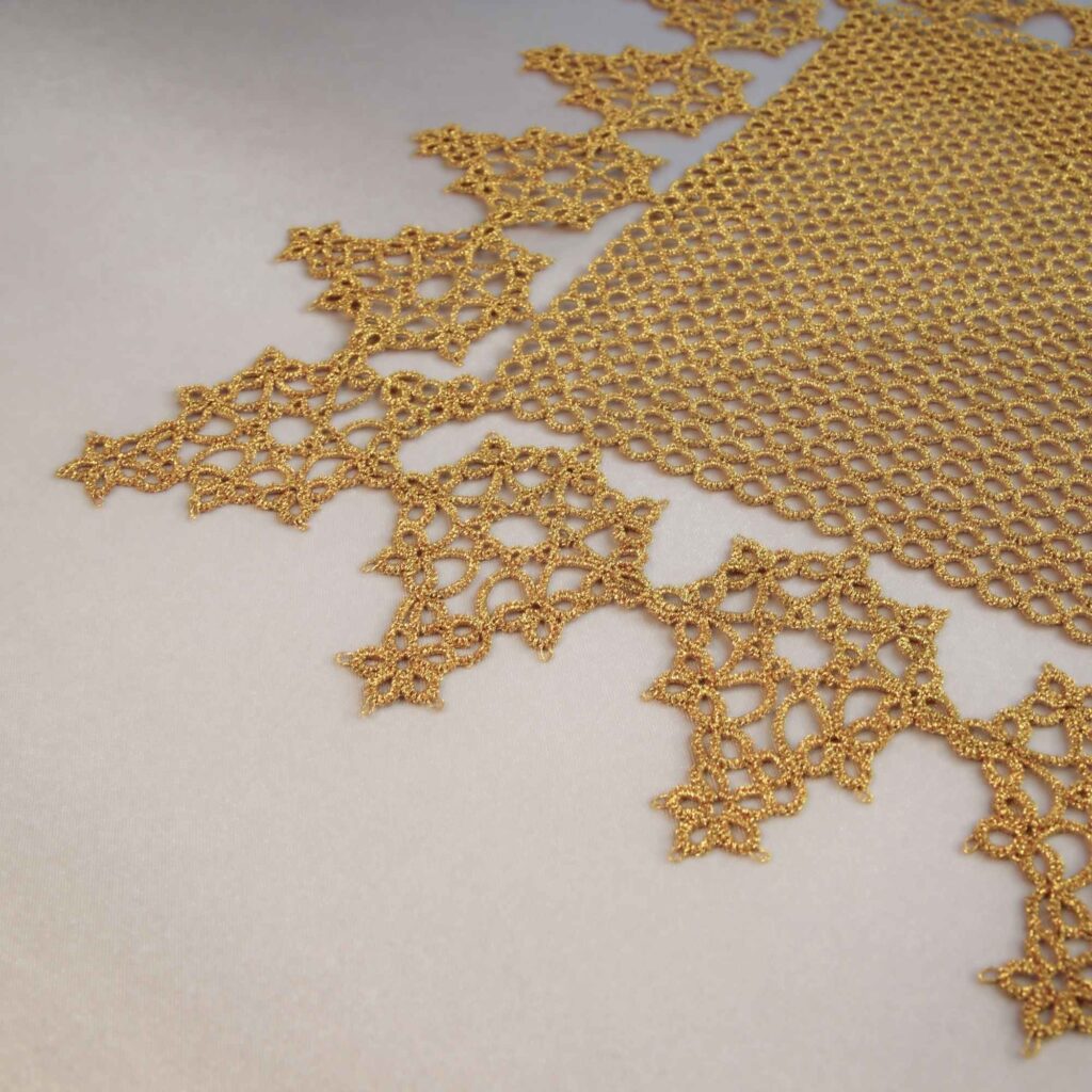 free tatting doily pattern corner close-up showing leaf edging gold on cream satin